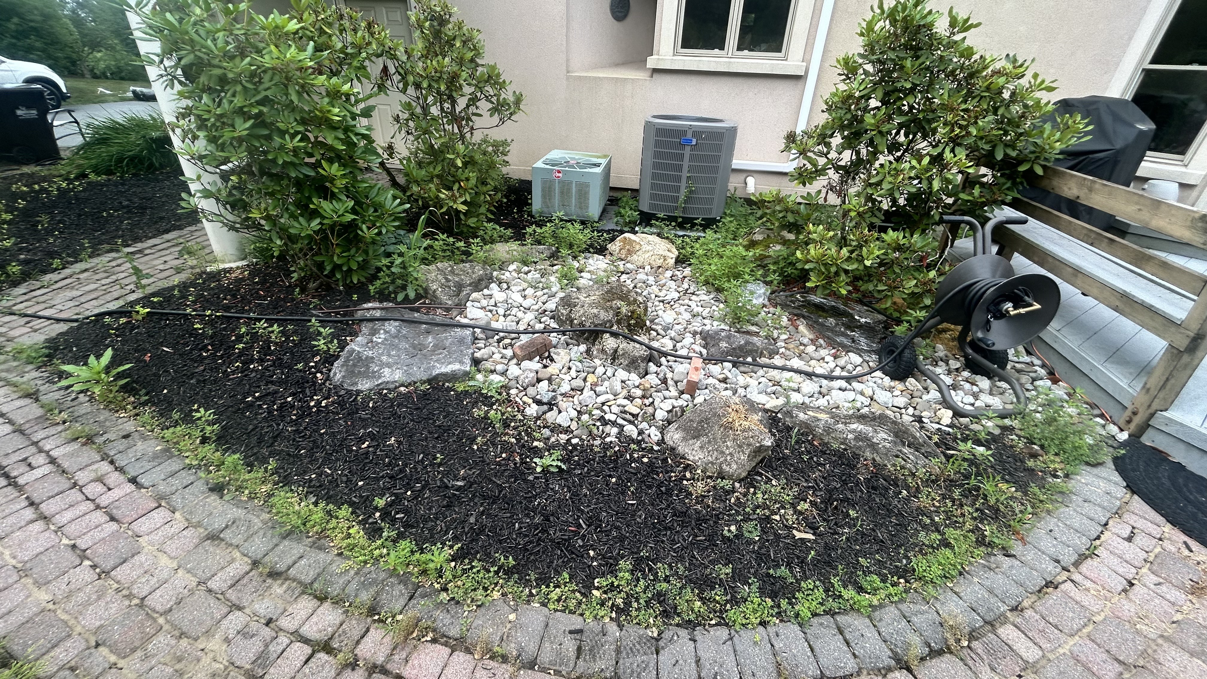 After: Beautiful HVAC area transformation with professional mulch and stone work