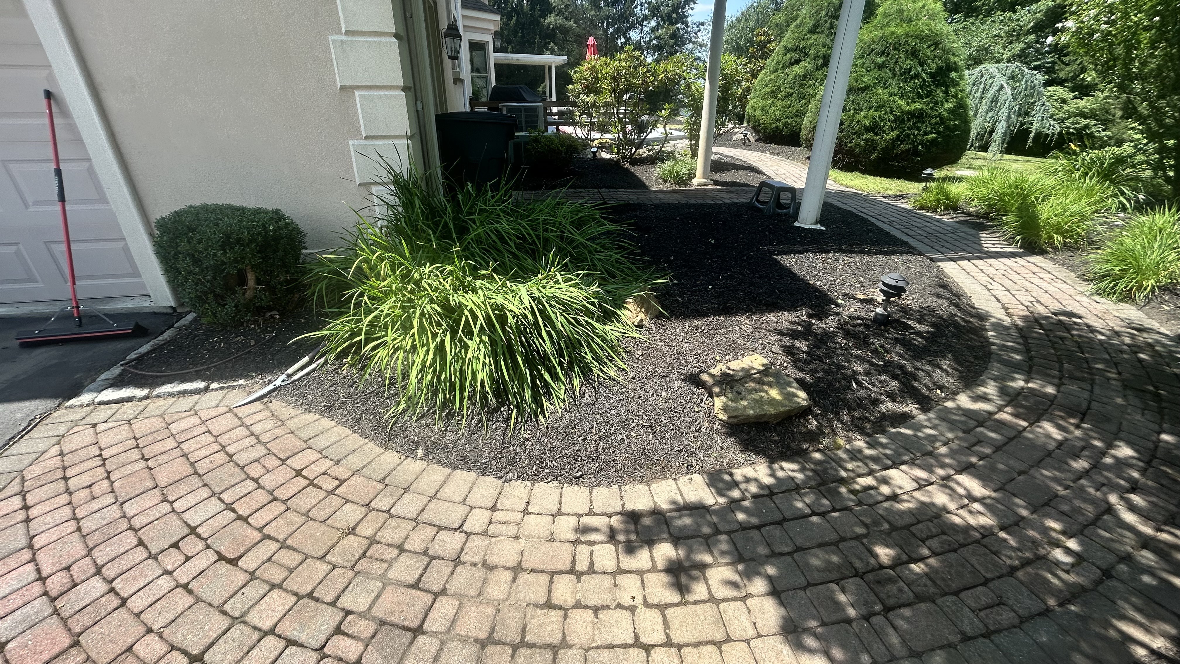 After: Beautifully transformed landscape with professional mulch installation and maintained plantings